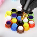 Honeycomb tattoo ink cups with interlocking design and smooth edges for professional tattoo use