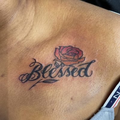 Customer’s Blessed script tattoo work with rose design on shoulder – fresh glossy appearance of the client’s personalized tattoo